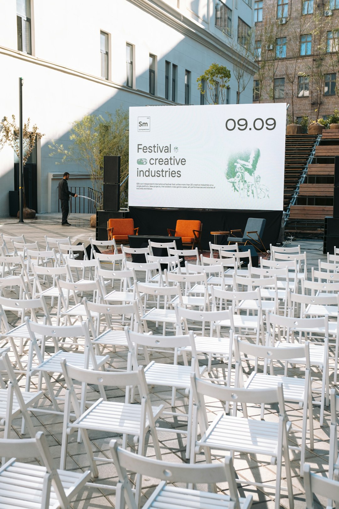a-group-of-white-tables-and-chairs-outside-uspemrmbacw
